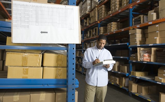 Man inspecting boxes in distribution warehouse