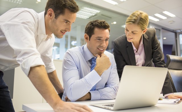 Business team of three in office and planning work