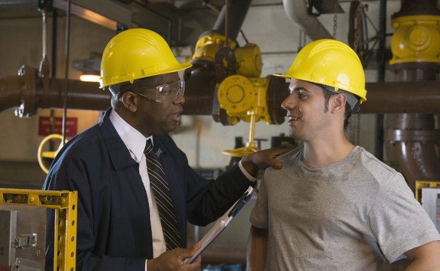 Manager and worker in waste treatment plant