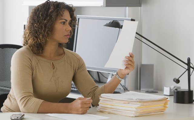 African businesswoman reading paperwork