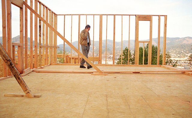 Businessman walking through house under construction