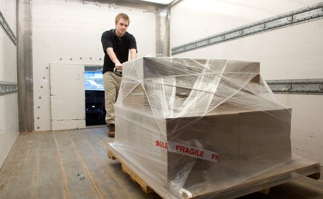 Man loading freight onto delivery truck