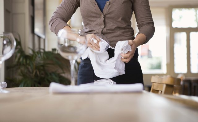 Waitress cleaning glasses