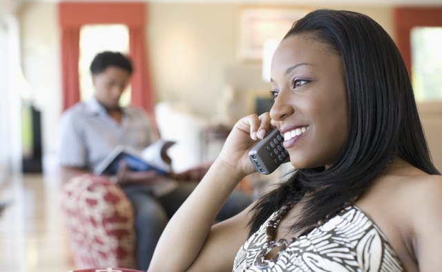 Close-up of a young woman talking on a cordless phone