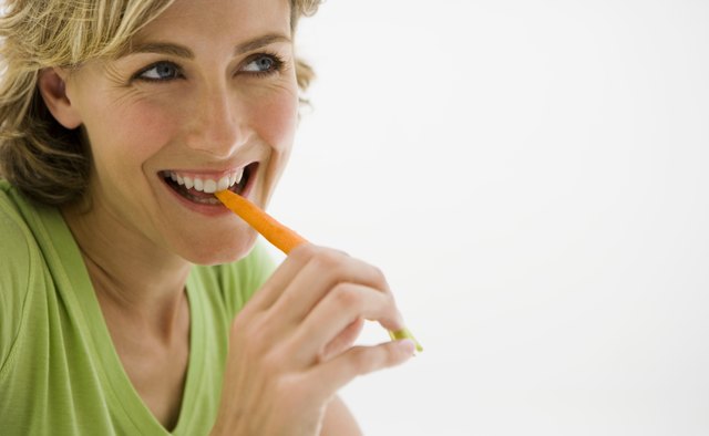 Woman eating carrot