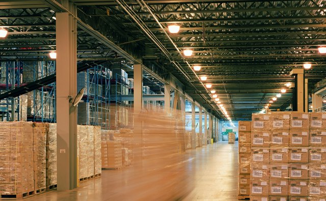 Aisle of warehouse, boxes stacked for distribution (blurred motion)