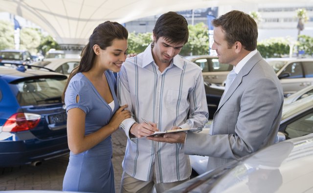 Couple signing for car