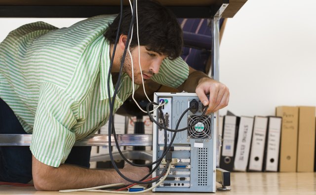 Man working on computer under desk