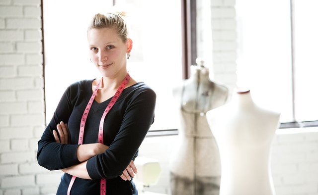 Seamstress posing by mannequins
