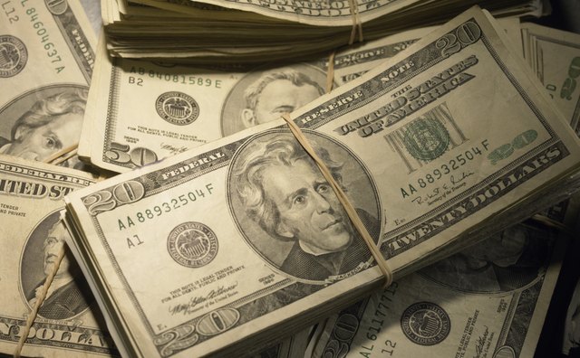 US Currency: Wads of US bills fastened with rubber bands, close-up