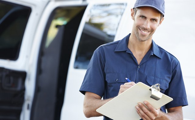 Portrait Of Delivery Driver With Clipboard