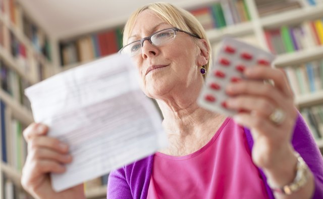 Senior woman with medication pills and prescription