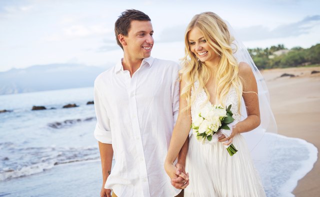 Bride and Groom Walking on Beautiful Tropical Beach at Sunset