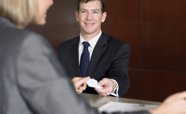 Businessman Giving a Receptionist His Business Card