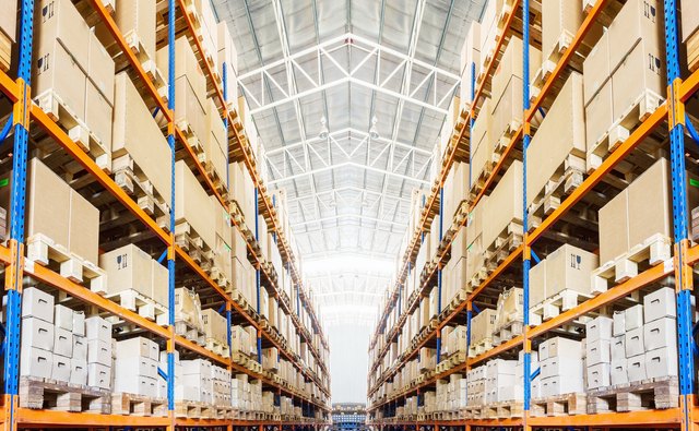 Rows of shelves with boxes in modern warehouse