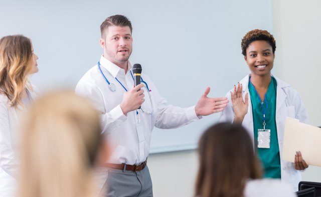 Doctor introduces colleague during healthcare seminar