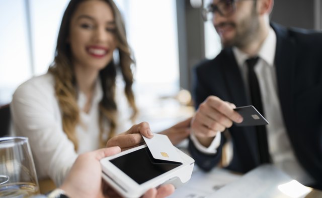 Business team completing transaction with credit card