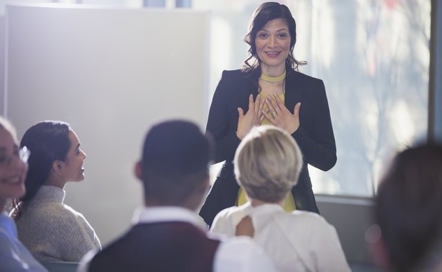 Businesswoman gesturing, leading conference meeting