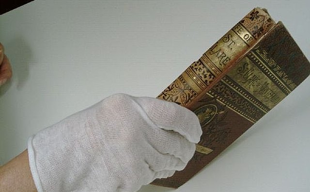 USE GLOVE TO KEEP FINGERPRINTS FROM MARKING PAGES