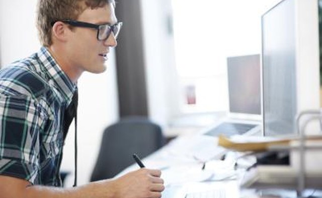 Man sitting behind computer at desk