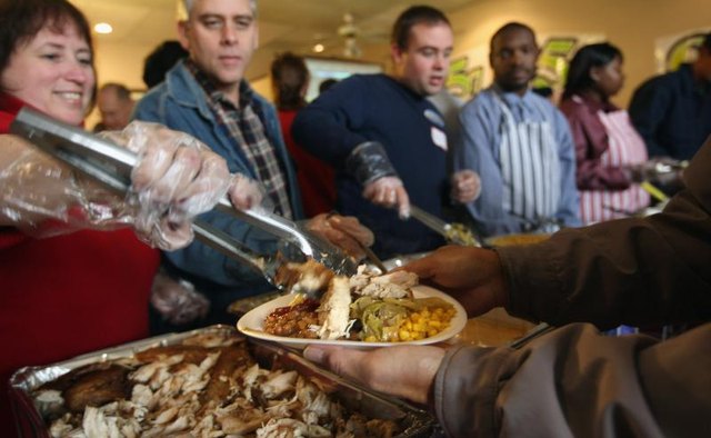 Volunteers feed the homeless at Thanksgiving.