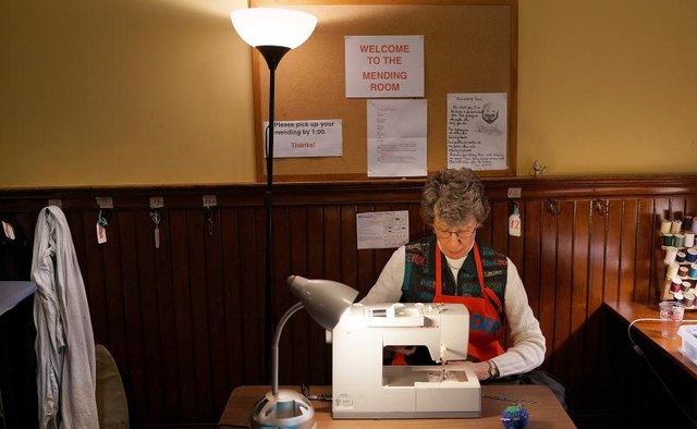 A woman sewing at a machine in a ministry.