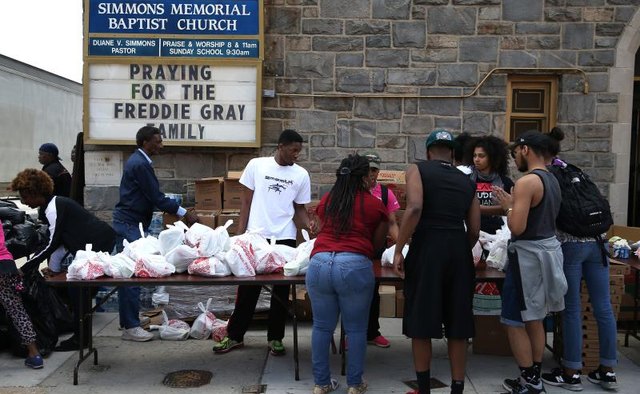 A church distributing bags of food during a food drive.