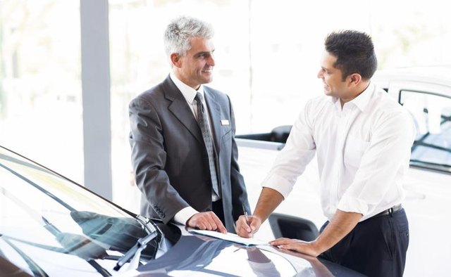 A customer discusses a lease agreement with a car dealer