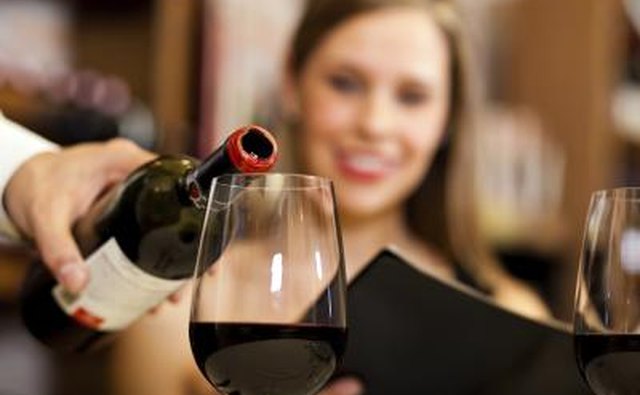 Waiter pouring wine