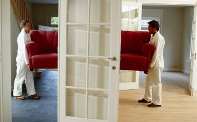 Men remove sofa from house