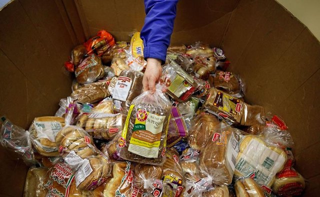 A collection of bread in a large cardboard box