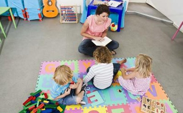 Children on mat listen to care giver