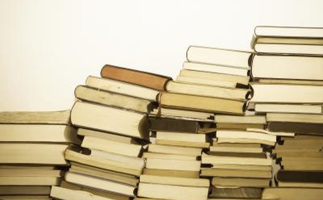 Assortment of used books leaning against wall