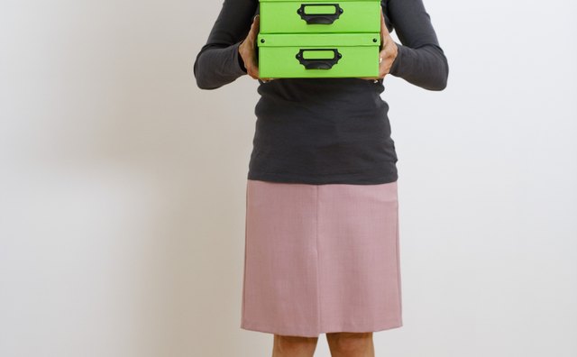 Woman holding stacked boxes