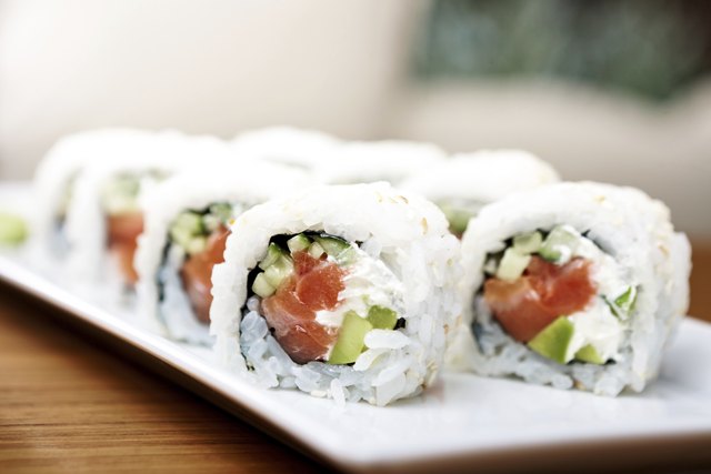 Well-mannered Japanese nibble on pieces of sushi.