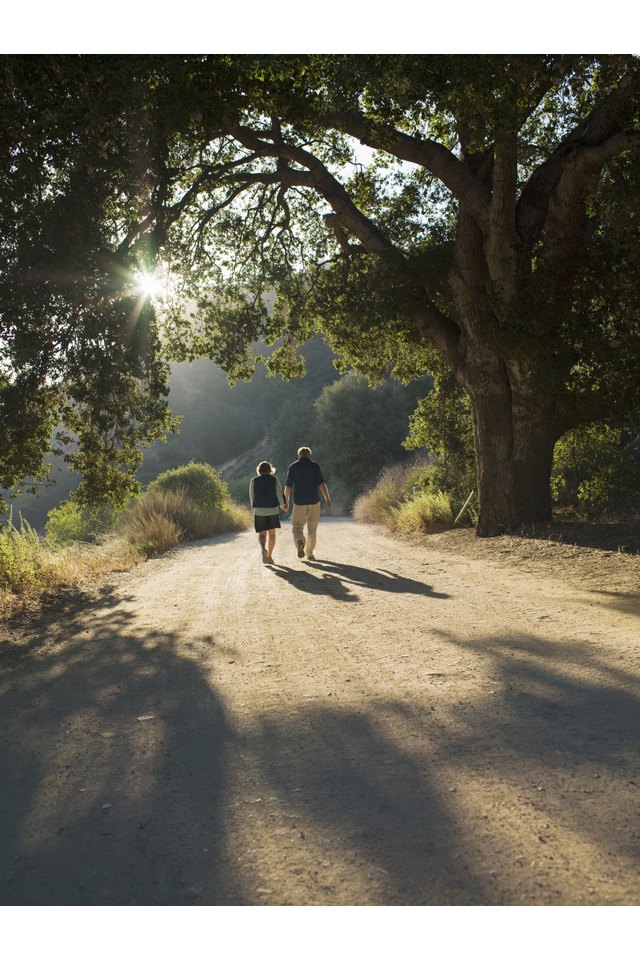 Mature couple walking down dirt road