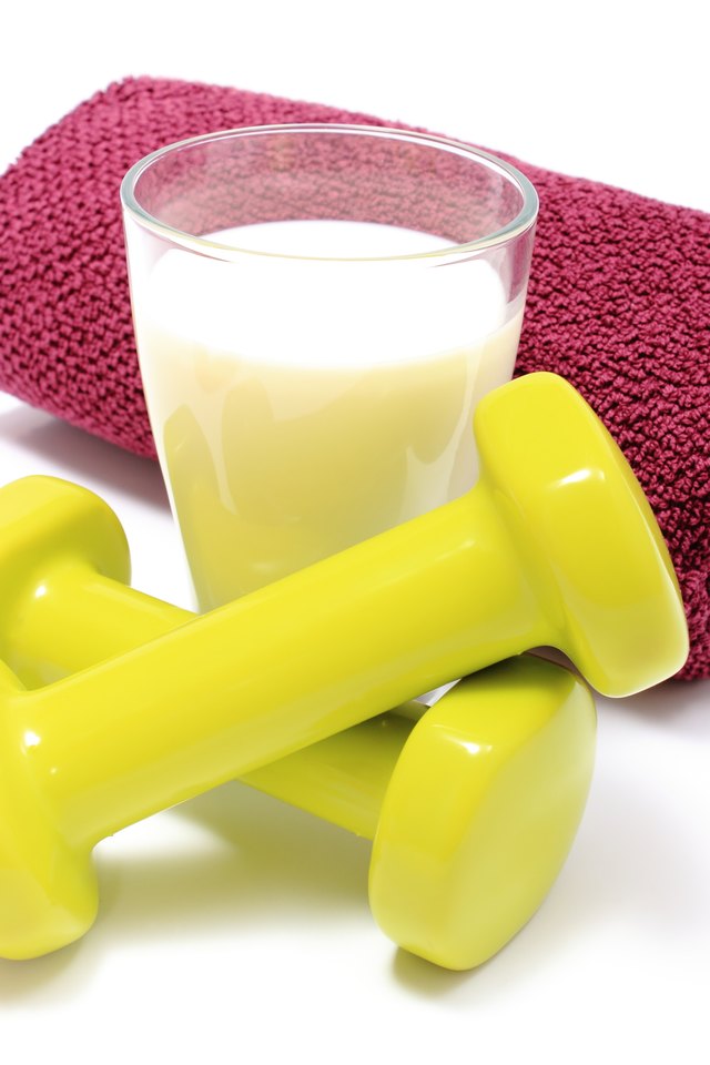 Dumbbells, towel for using in fitness and glass of milk