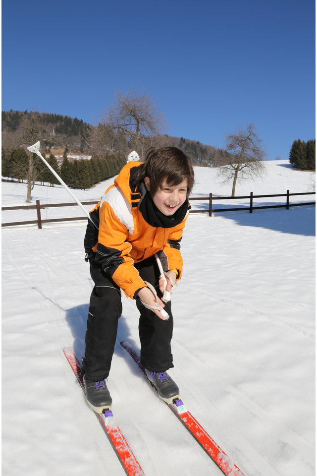 young boy goes on cross-country skis on the white snow