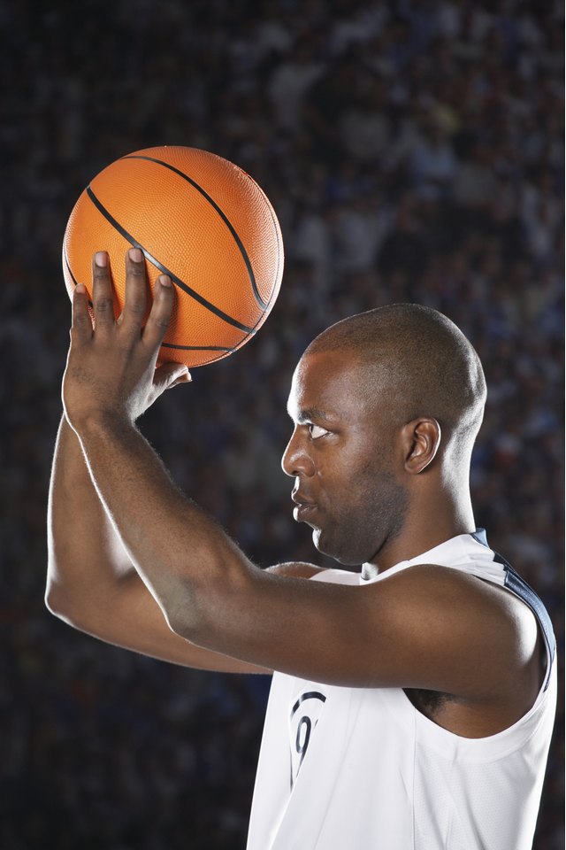 Basketball player lining up shot on court, side view, close up