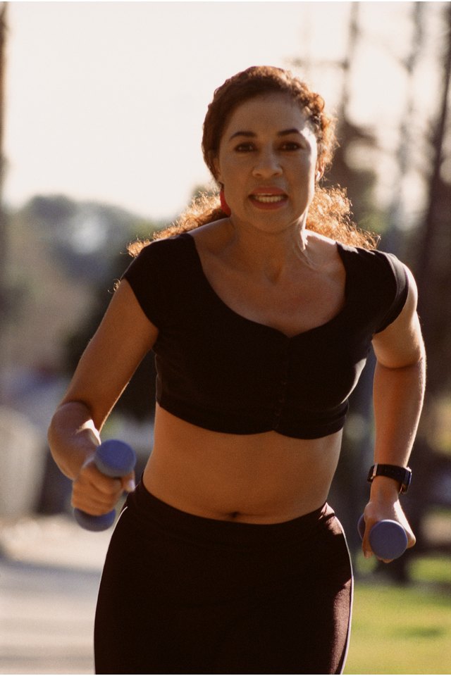 Woman running with hand weights