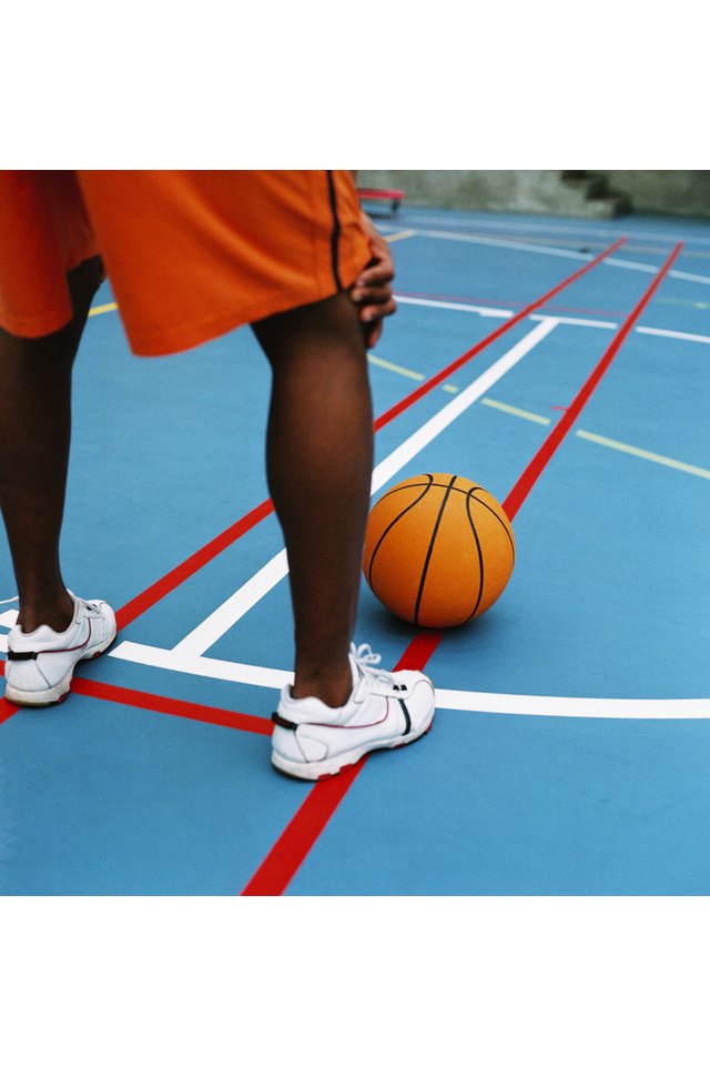 close-up from behind of the legs of a basketball player resting during a game