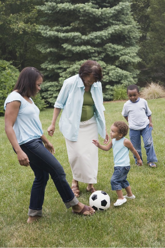 Three generation family playing soccer