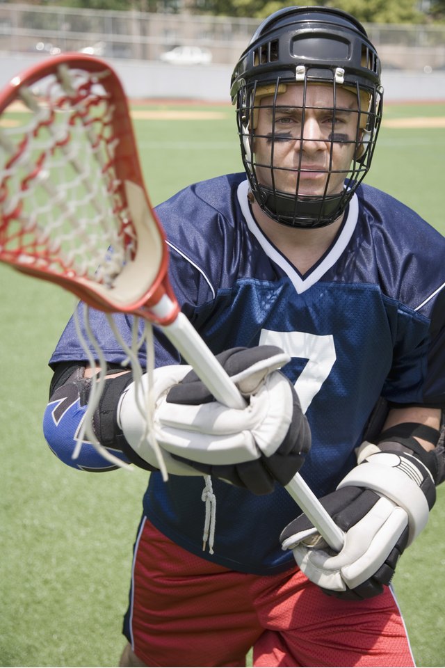 Serious lacrosse player holding crosse