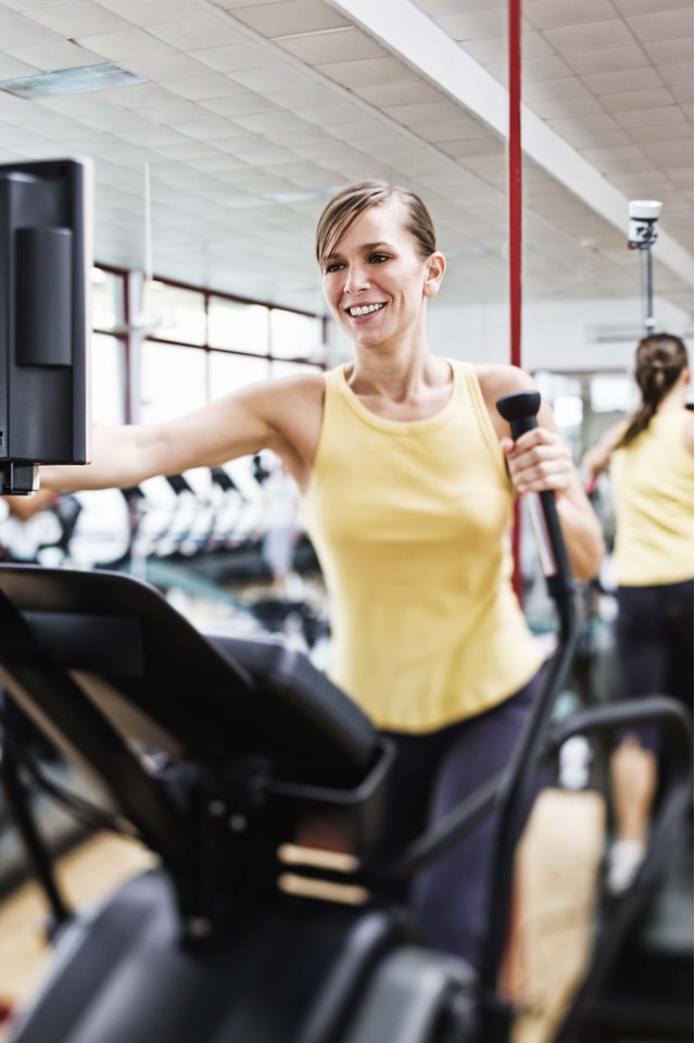 Woman exercising on elliptical machine