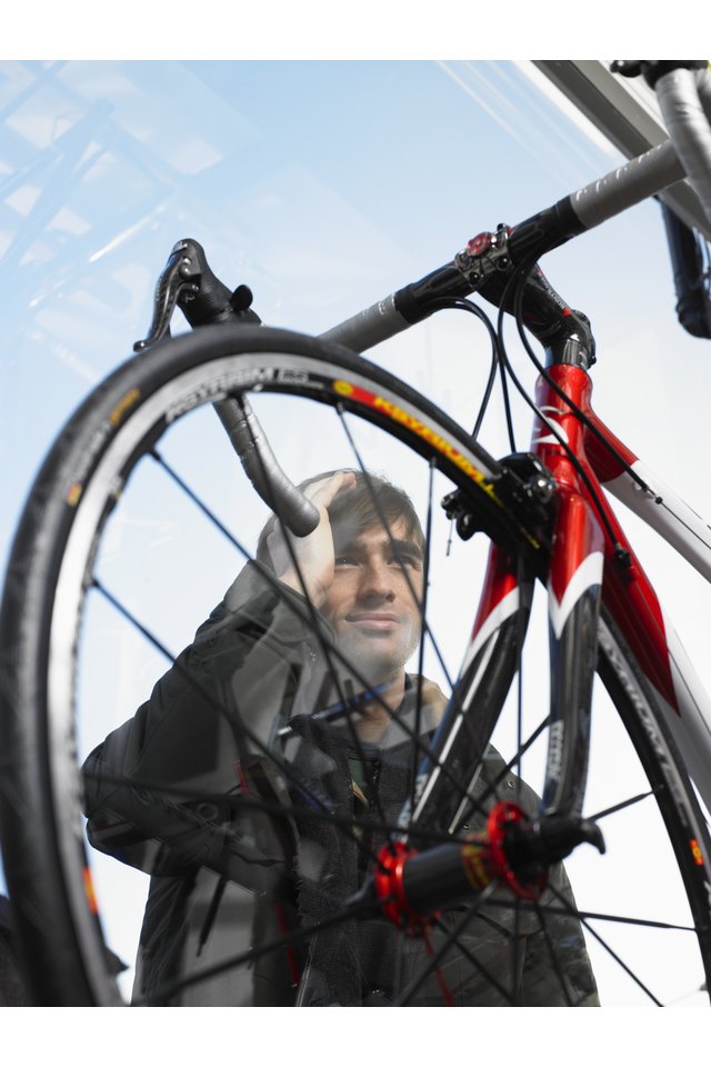 Man looking through window at bicycle, low angle view through glass