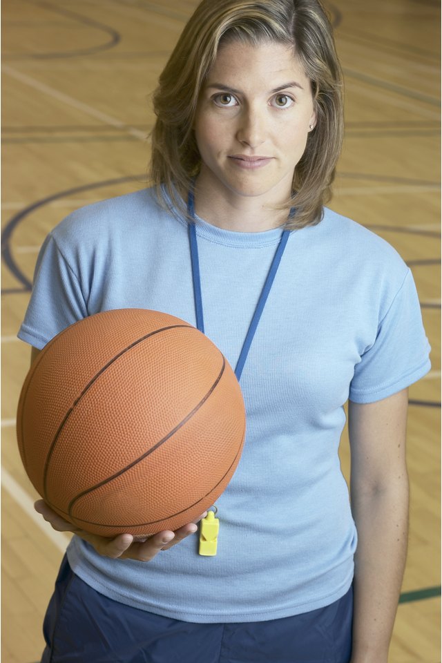 Gym coach with basketball