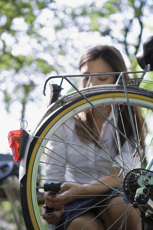 Woman fixing bicycle