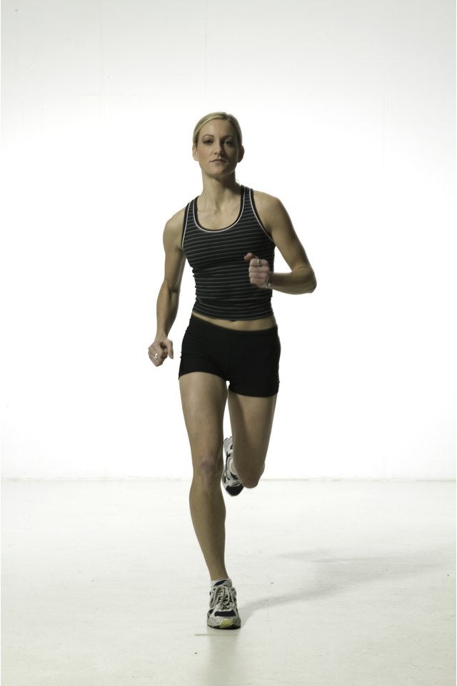 Young woman in shorts and vest,  running, portrait
