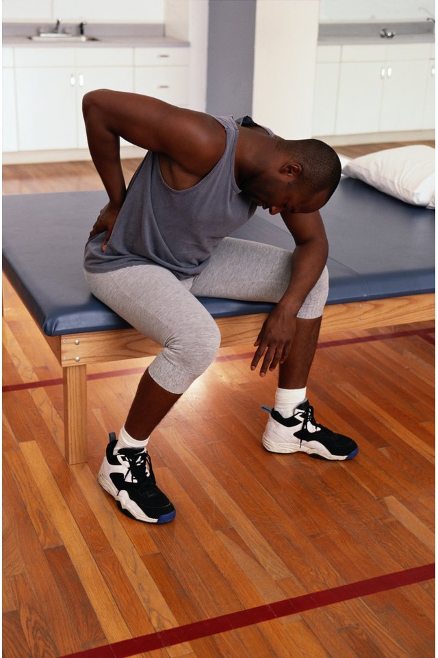 Man in Physical Therapy Holding His Back