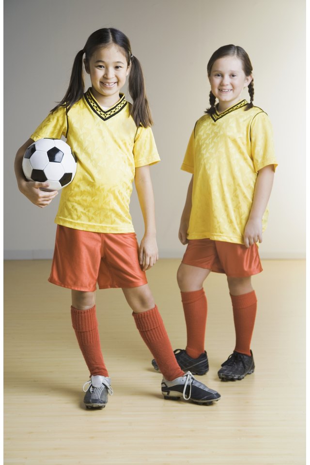 Portrait of two girls wearing soccer outfits